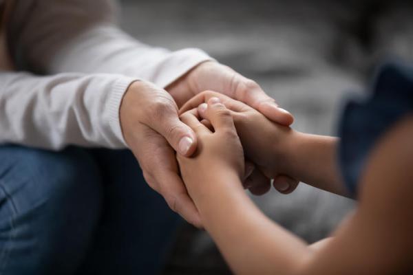 iStock/Getty Images Plus Adult holding child's hands